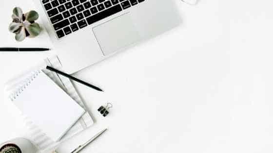 laptop on a desk with pens