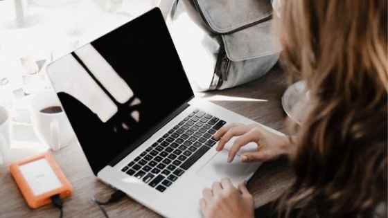 woman typing on a laptop